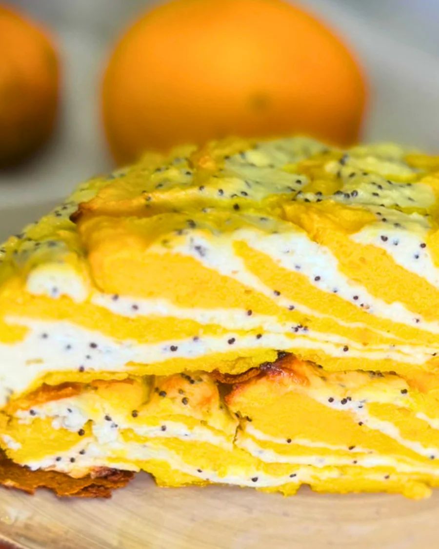 Close-up of marble pumpkin and cottage cheese casserole showing its soft texture, golden pumpkin layers, and creamy poppy seed filling.